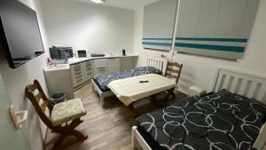 a room with two beds and a table and a desk at Lindenstraße in Belm