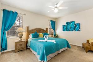 a bedroom with a bed with a swan on it at Gorgeous Davenport 5 Bed Villa with Pool Hot Tub in Davenport