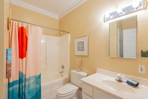 a bathroom with a toilet and a sink and a shower at 2B Pavilion Watch in Folly Beach