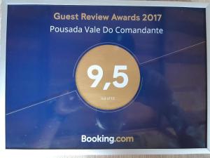 a sign for a guest review awards with the number at Pousada Vale Do Comandante in Macacos