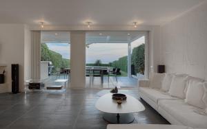 a living room with a white couch and a table at Luxurious Beachfront Villa Maira in Aghia Marina