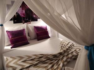 Tempat tidur dalam kamar di Pousada Flor de Pitaya
