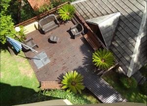 an overhead view of a patio with a bench and trees at Apartamento Borges Gramado in Gramado