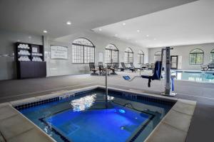 a swimming pool in a building with a swimming pool at Staybridge Suites - Holland, an IHG Hotel in Holland