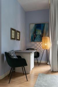 a room with a desk and two chairs and a lamp at De Rode Beuk in Wassenaar