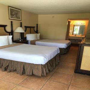 a hotel room with two beds and a window at Altamonte Springs Hotel and Suites in Orlando