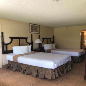 two beds in a hotel room with two beds at Altamonte Springs Hotel and Suites in Orlando