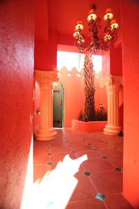 a hallway with columns and a chandelier in a building at A Fei Surf Inn III in Nanwan