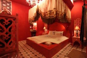 a bedroom with a bed in a red room at A Fei Surf Inn III in Nanwan