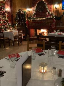 a dining table with a christmas tree in a restaurant at Margaret's Island Hotel in Naousa