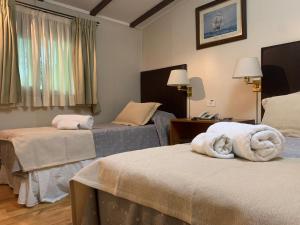 Ένα ή περισσότερα κρεβάτια σε δωμάτιο στο Hotel Nordico