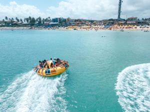 a group of people riding on a raft in the water at Portal do Atlântico in Barra de São Miguel