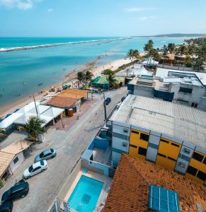 an aerial view of a beach with buildings and the ocean at Portal do Atlântico in Barra de São Miguel