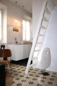a white staircase in a kitchen with a table and a chair at Apartamentos Casa del Coronel in Tarifa +33 photos