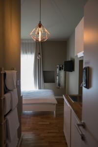 a room with a bed and a kitchen with a window at S&L1 REPUBLIC ZAGREB CENTER in Zagreb