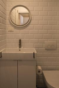 a white bathroom with a sink and a mirror at S&L1 REPUBLIC ZAGREB CENTER in Zagreb