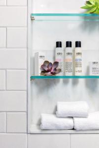 a shelf with towels and other products in a bathroom at Walker Hotel Greenwich Village in New York