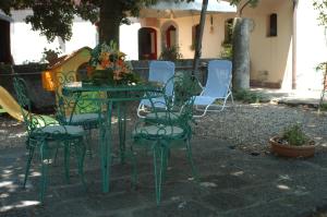 an outdoor table and chairs with flowers on it at B&B Sotto i Pini in Zafferana Etnea