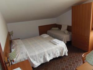 En eller flere senger på et rom på Hotel Italia