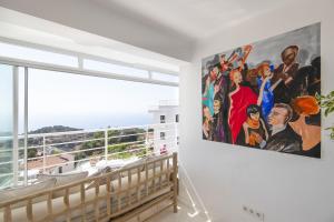 a large painting on a wall in a room with a window at Highclere Hotel and Spa in Faralya
