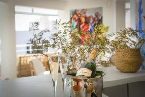 a bottle of champagne in a bucket on a table with glasses at Highclere Hotel and Spa in Faralya