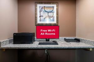 a desk with a sign that reads free wifi all rooms at Red Roof Inn Dahlgren - Naval Base in Dahlgren