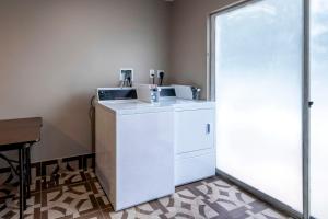 a white washer and dryer in a room at Red Roof Inn Dahlgren - Naval Base in Dahlgren