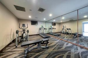 a gym with treadmills and ellipticals and mirrors at Red Roof Inn Dahlgren - Naval Base in Dahlgren