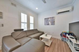 a living room with a couch and a flat screen tv at 1000#3 Renovated Home by Beach & Sand - AC & More! in Newport Beach