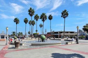 a plaza with palm trees and a fountain with a ball at 1000#3 Renovated Home by Beach & Sand - AC & More! in Newport Beach +17 photos