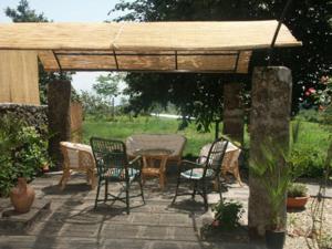 a patio with a table and chairs under a pavilion at B&B Sotto i Pini in Zafferana Etnea