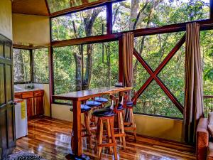 a room with a bar in a tree house at Quality Cabins Monteverde in Monteverde Costa Rica