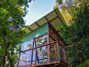 a tree house with a balcony in the trees at Quality Cabins Monteverde in Monteverde Costa Rica