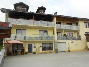 a large yellow building with a patio in front of it at Apartment in the Bavarian Forest with balcony in Drachselsried