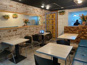 a restaurant with tables and chairs with a laptop at Rivière Boutique Hotel in Medellín
