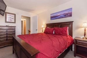 Un dormitorio con una gran cama roja y una cómoda. en Mammoth View Villas # 34, en Mammoth Lakes