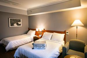 Tempat tidur dalam kamar di Hotel Paragon