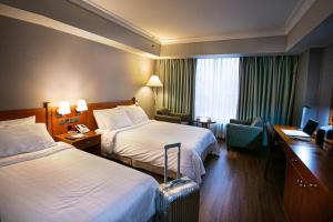Cama o camas de una habitación en Hotel Paragon