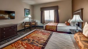 a hotel room with two beds and a desk at Best Western Plus Battleground Inn & Suites in Battle Ground +17 photos