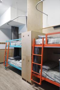 a bunk bed with two bunk beds in a room at Canmore Downtown Hostel in Canmore