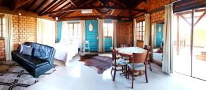 a living room with a couch and a table at Pousada Doce Mar in Guarda do Embaú