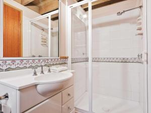 a bathroom with a sink and a shower at Banjo Apartments in Thredbo