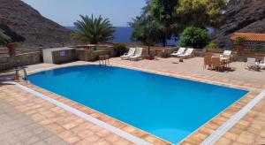 a large swimming pool with blue water in a yard at Blue Ocean Camp - Tasartico in Tasartico