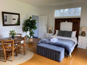 a bedroom with a bed and a table and a tableablish at Ravenswood Homestead in Ravenswood