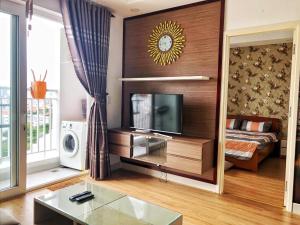 a living room with a bed and a tv in a room at Luxury Cookies Apartment Vung Tau Gold Sea Melody in Vung Tau