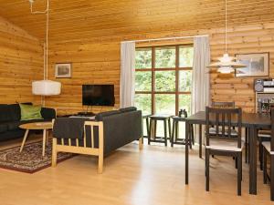 a living room with a table and a dining room at Peaceful Holiday Home in Jutland with Sauna in Ebeltoft