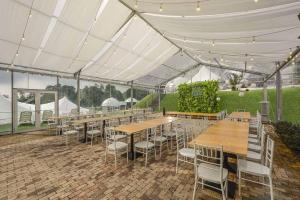 a tent with tables and chairs in a patio at Glamz at Genting in Genting Highlands