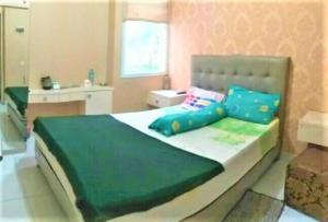 a bedroom with a large bed with blue pillows at Barata Hotel AR1 in Tangerang +25 photos