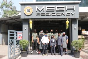 a group of men standing outside of a building at MEGH RESIDENCY in Navi Mumbai