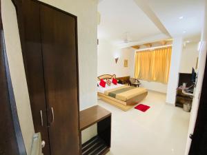 a living room with a bed and a couch in a room at Hotel The Galaxy in Jabalpur